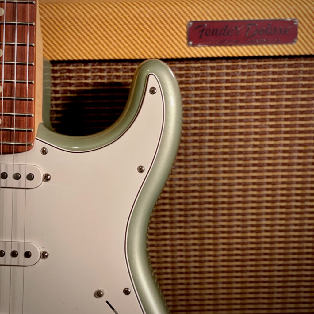 This photo shows a close-up of my Fender Player Stratocaster, leaning against the front of the Fender Tweed Deluxe amplifier.