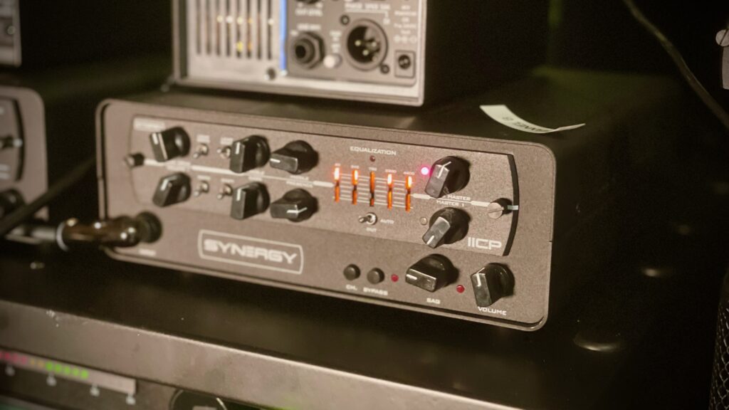 This photo shows the front of the Synergy IICP preamp module, sat inside a Synergy SYN-1 enclosure.

The red glow of the IICP's distinctive 5-band graphic equaliser is clearly visible.