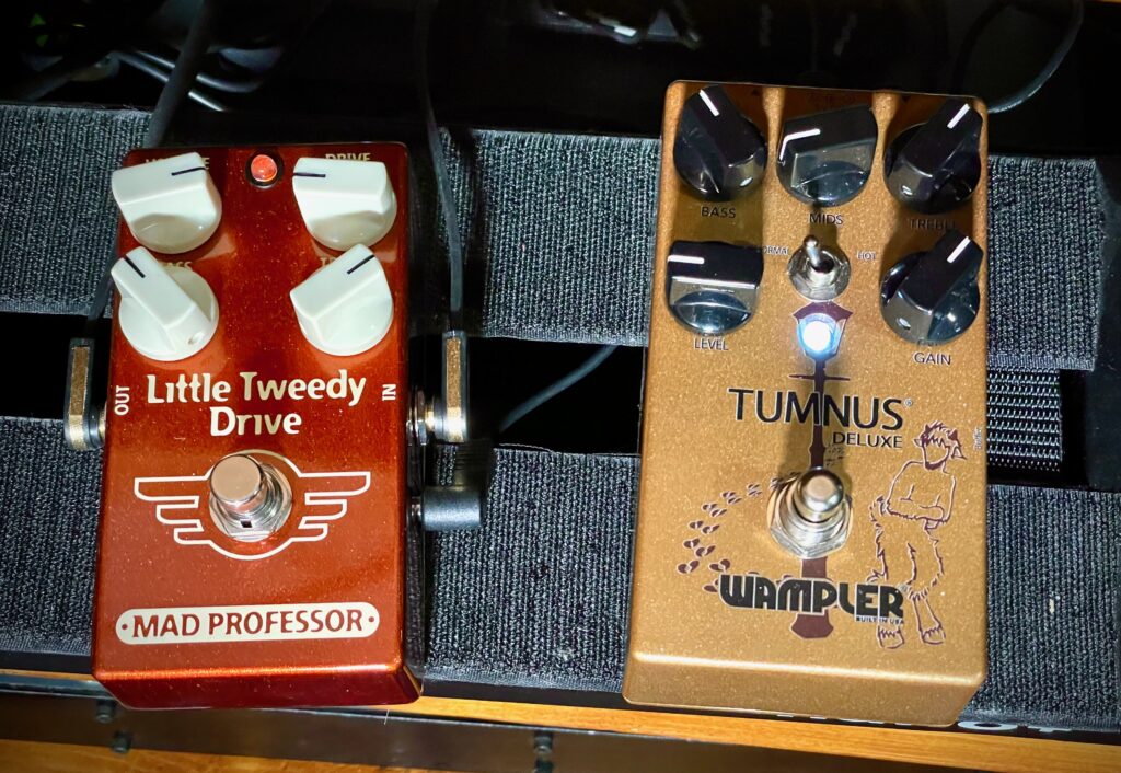This photo shows a top-down view of the Little Tweedy Drive and the Wampler Tumnus Deluxe.

The settings on the Little Tweedy Drive are:

- Volume: just below 3 o'clock
- Gain: just below 10 o'clock
- Bass: around 10:30
- Treble: around 1:30

The settings on the Tumnus Deluxe are:

- Bass: around 11 o'clock
- Mid: around 8 o'clock
- Treble: around 1 o'clock
- Level: at 9 o'clock
- Gain: around 1 o'clock
