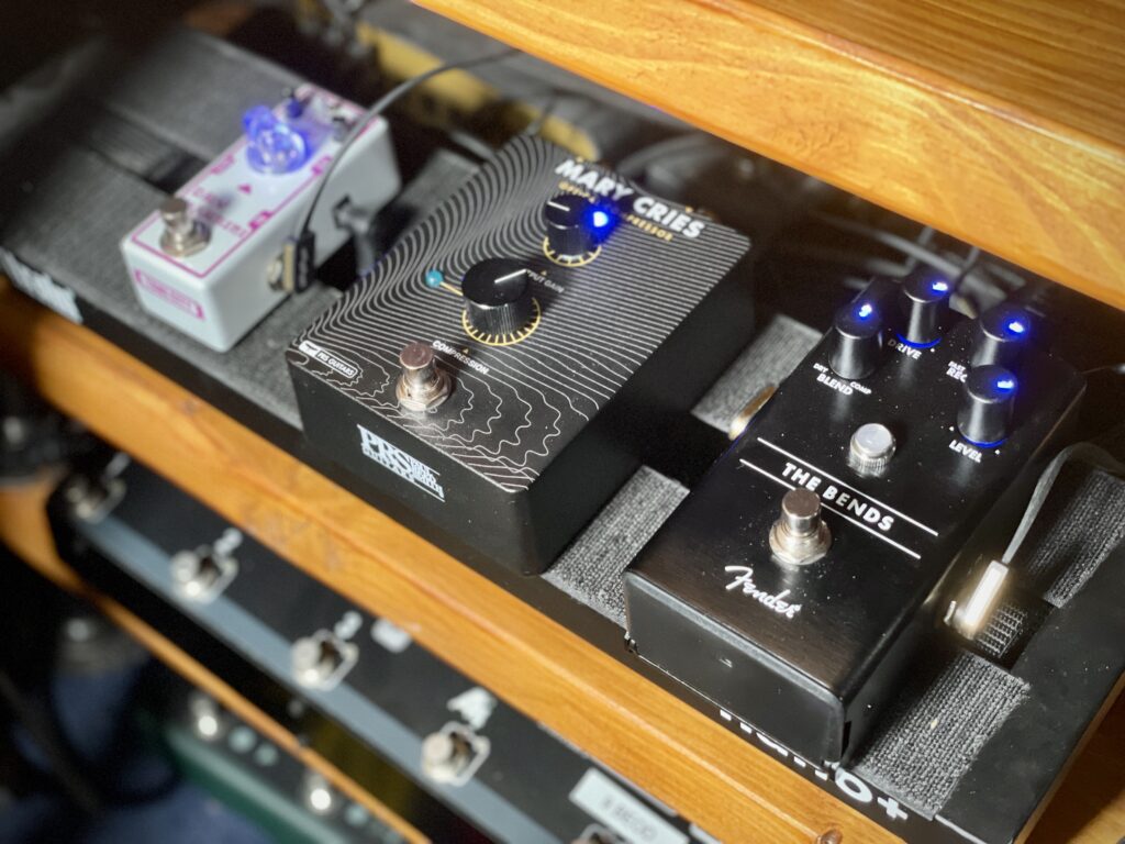 The photo shows three pedals on my pedalboard: Tone City's Dry Martini overdrive pedal, PRS's Mary Cries optical compressor, and Fender's The Bends compressor.