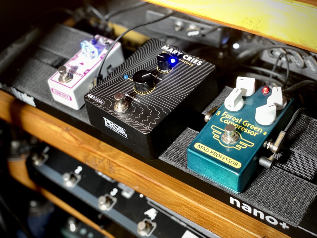 The photo shows three pedals on my pedalboard: Tone City's Dry Martini overdrive pedal, PRS's Mary Cries optical compressor, and Mad Professor's Forest Green Compressor.