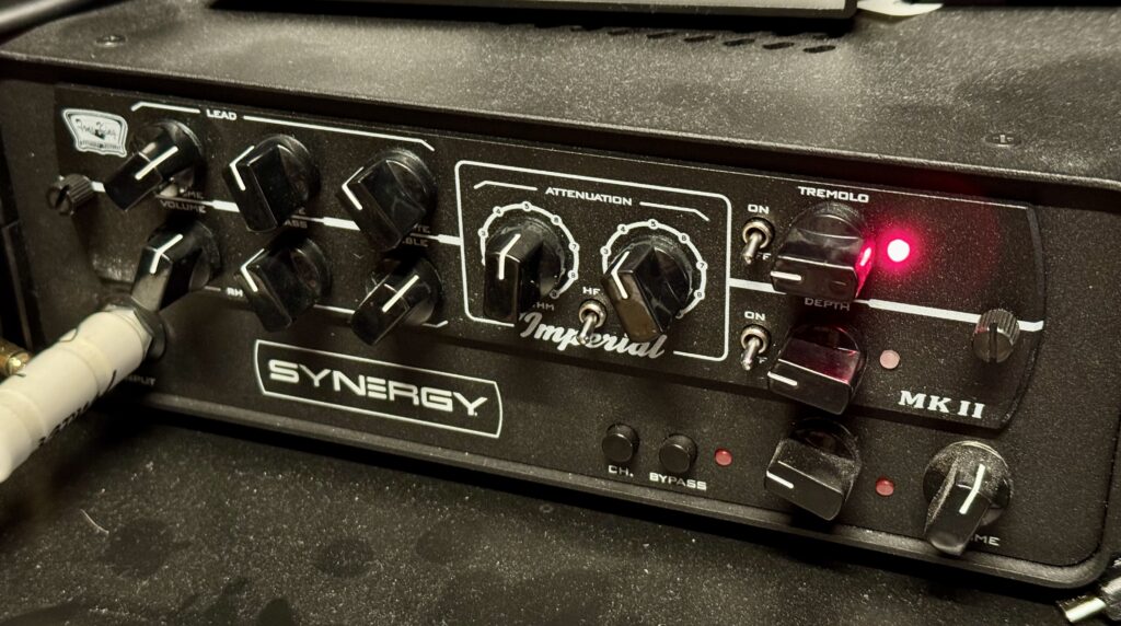 This is a photo of the Imperial MKII preamp module in a (dusty!) Synergy SYN-1 housing.

On the left of the module, there are two rows of three pots, one row per channel.

The top row of three controls are for the Lead channel (the tweed-voiced overdrive channel). They are labelled Volume, Tone, and Mid Bite.

The bottom three controls are for the Rhythm channel (the blackface-voiced clean channel). They are labelled Volume, Bass and Treble.

Next to them are two large, fixed stepped controls. These are the Attenuation controls, one for each channel.

There's a mini toggle switch nestled in between the two large controls. This enables a high-frequency cut.

On the right, there are two more toggle switches, to switch on the built-in, valve-driven tremolo. Next to them are two more pots, for controlling the speed and depth of the tremolo circuit.